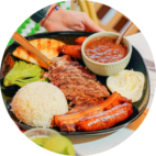 Authentic Colombian Bandeja Paisa platter with grilled steak, chicharron, rice, and beans at Garden House Restaurant