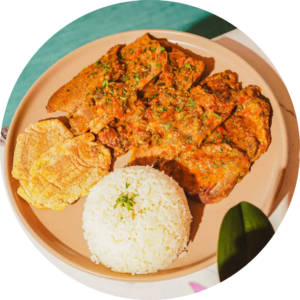 Grilled chicken breast platter served with white rice and fried green plantains at Garden House Restaurant